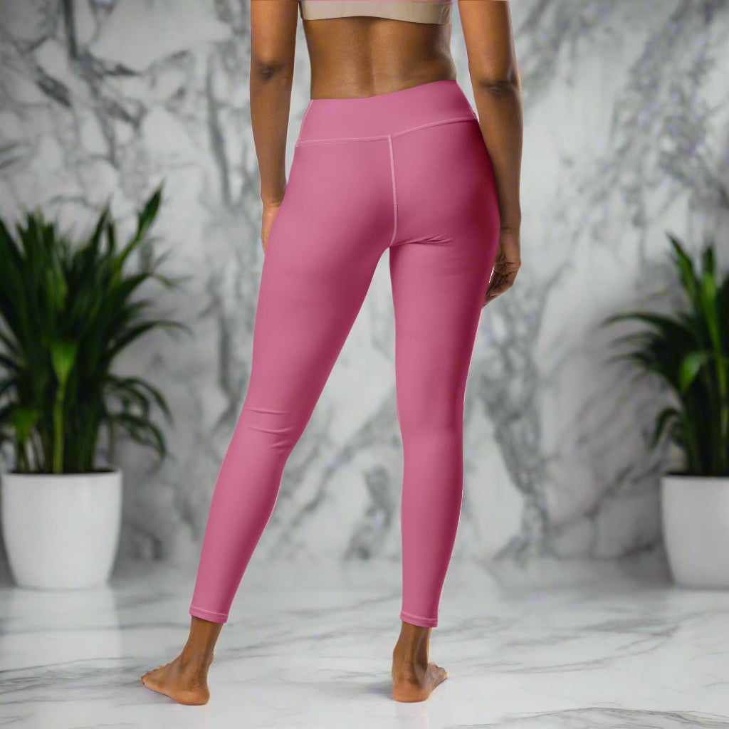 A woman modeling the Petalburn Yoga Leggings in Ritual Rose. High-waisted, long-length yoga leggings featuring UV protection, four-way stretch, and body contouring fit.