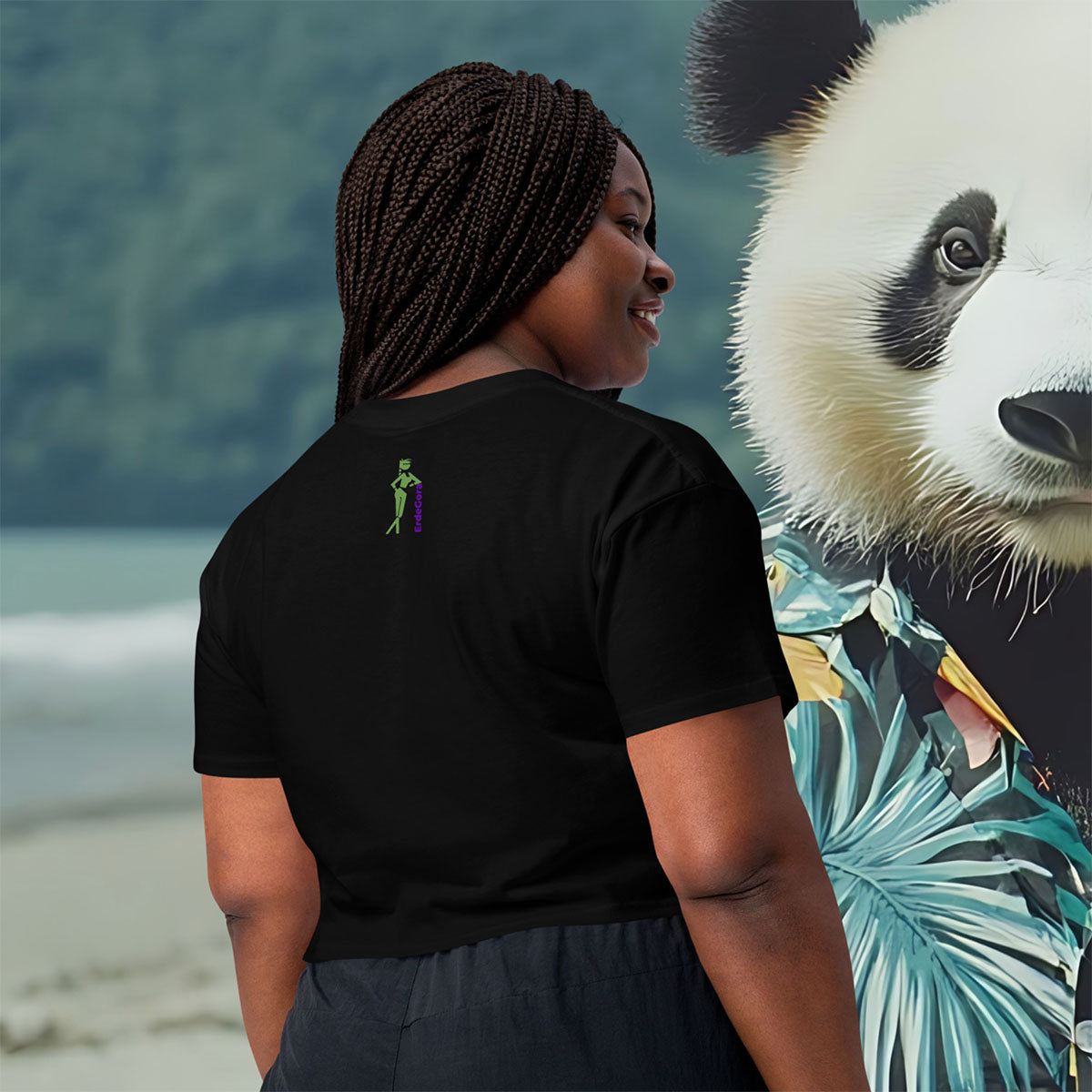 Person wearing a black t-shirt with erdegora logo, standing next to a huge panda wearing a Hawaiian shirt.