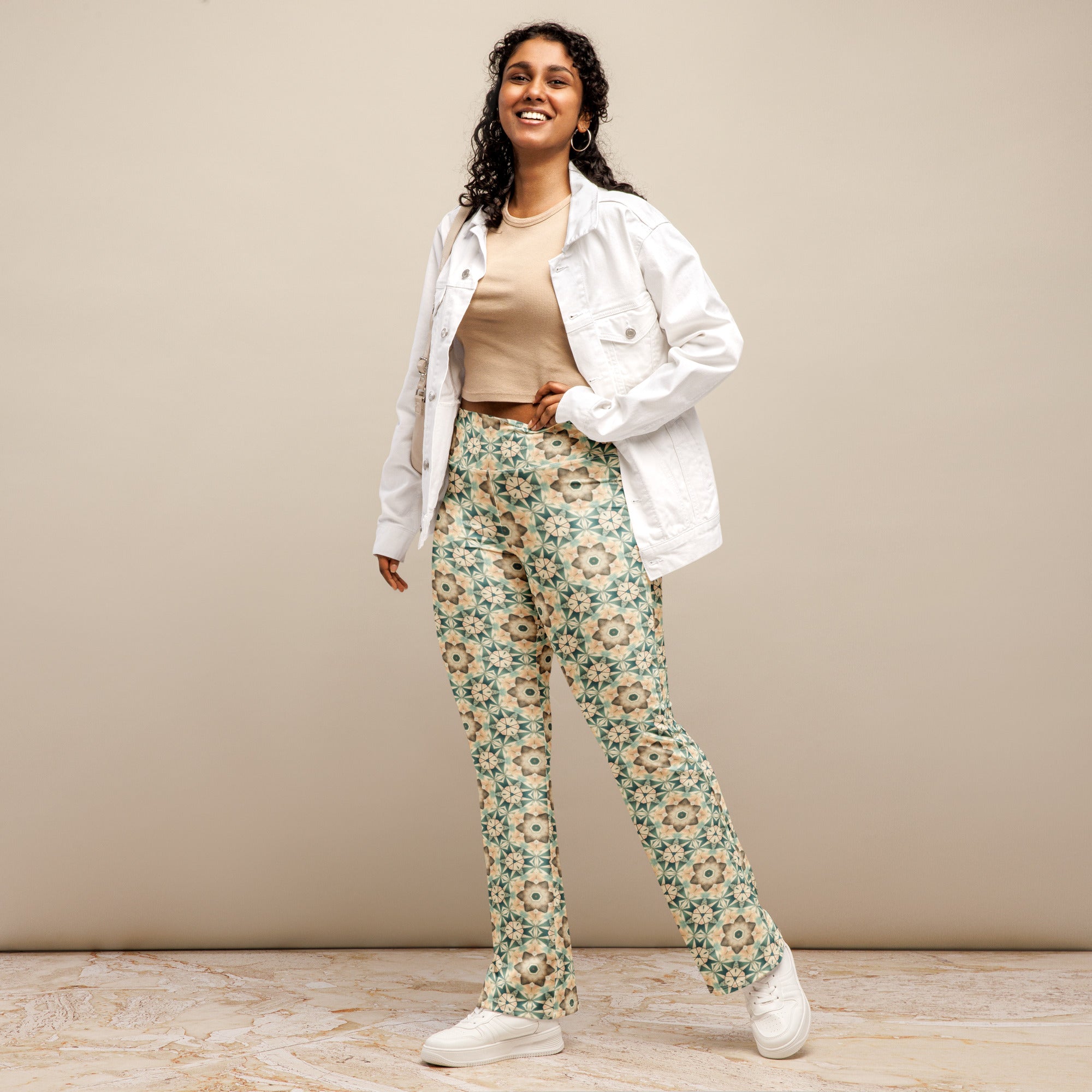 Flared leggings with a colorful mandala mosaic print, featuring a high waist and flared bottoms.