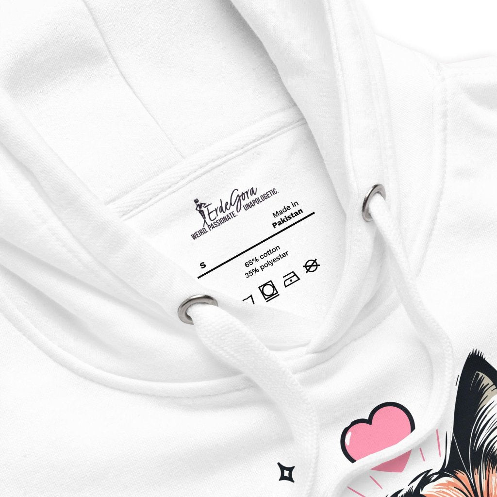 Close-up view of the neck and label on the Erdegora premium white hoodie, featuring the "Schattig" cat design and product care information.