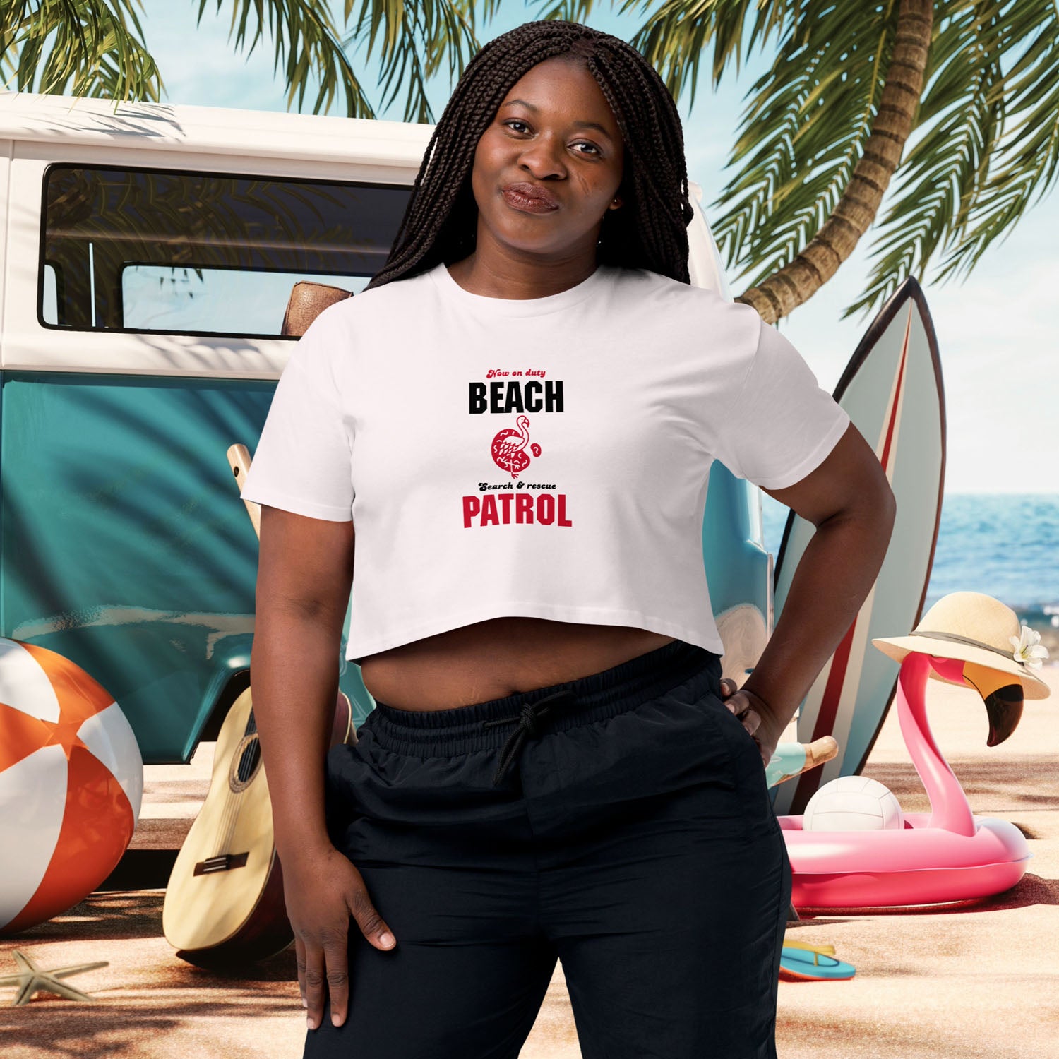 Front view of a women's Y2K-style crop tee in orchid color, featuring a retro flamingo beach patrol graphic. The shirt is displayed flat against a white background.