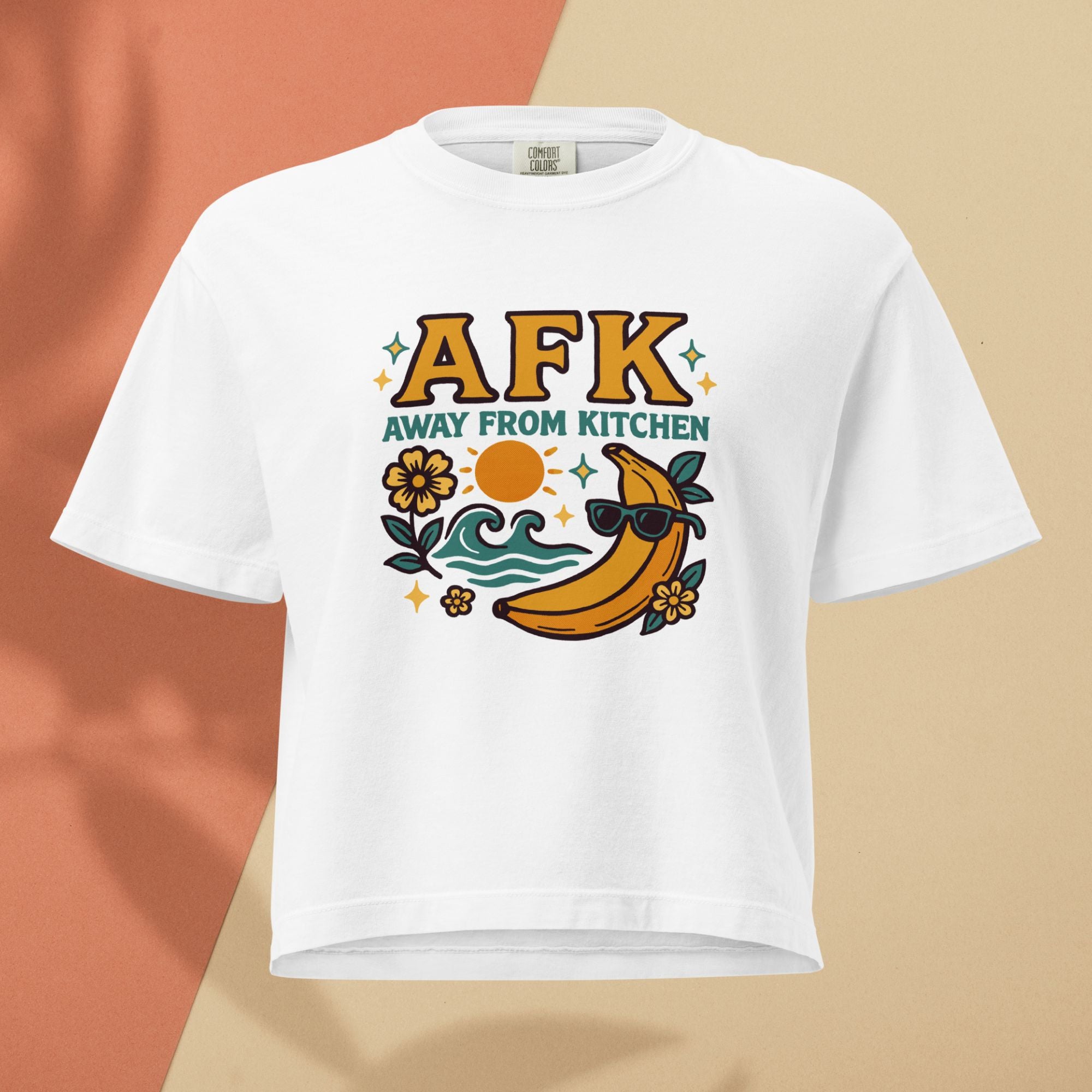 White t-shirt with 'AFK Away From Kitchen' graphic design featuring a banana wearing sunglasses on a beige background.