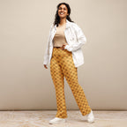 Model posing with hands on hips, wearing High-Rise Flared Leggings in Golden Emerald Tiles, showcasing the high-waisted fit, double-layered waistband, and flared bottom.