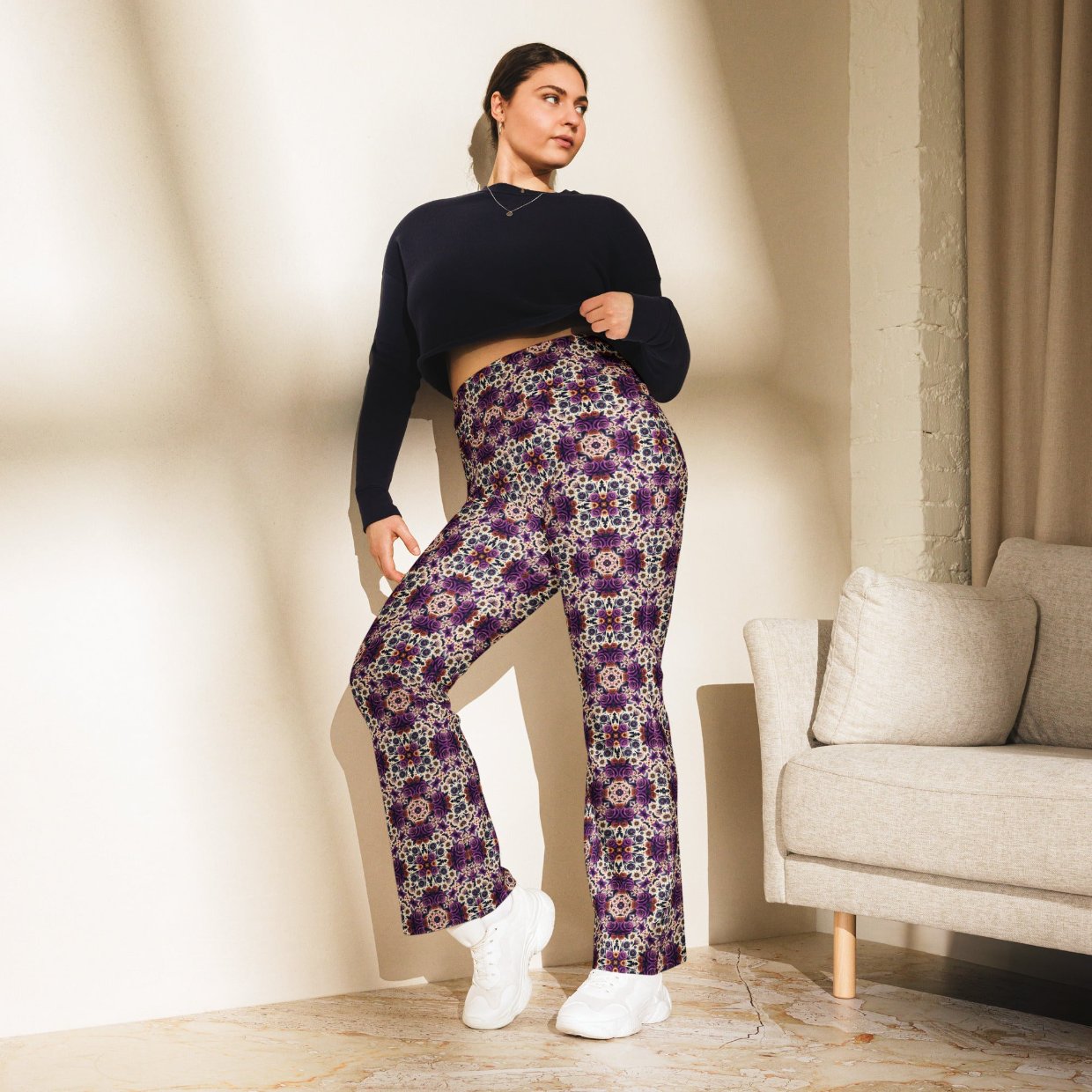 Flared leggings with a vibrant roses mandala print, featuring a high waist and flared bottoms, worn by a model.