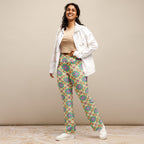  High-rise flared leggings with a vibrant retro garden pattern, featuring a high waist and flared bottoms, worn by a smiling model.