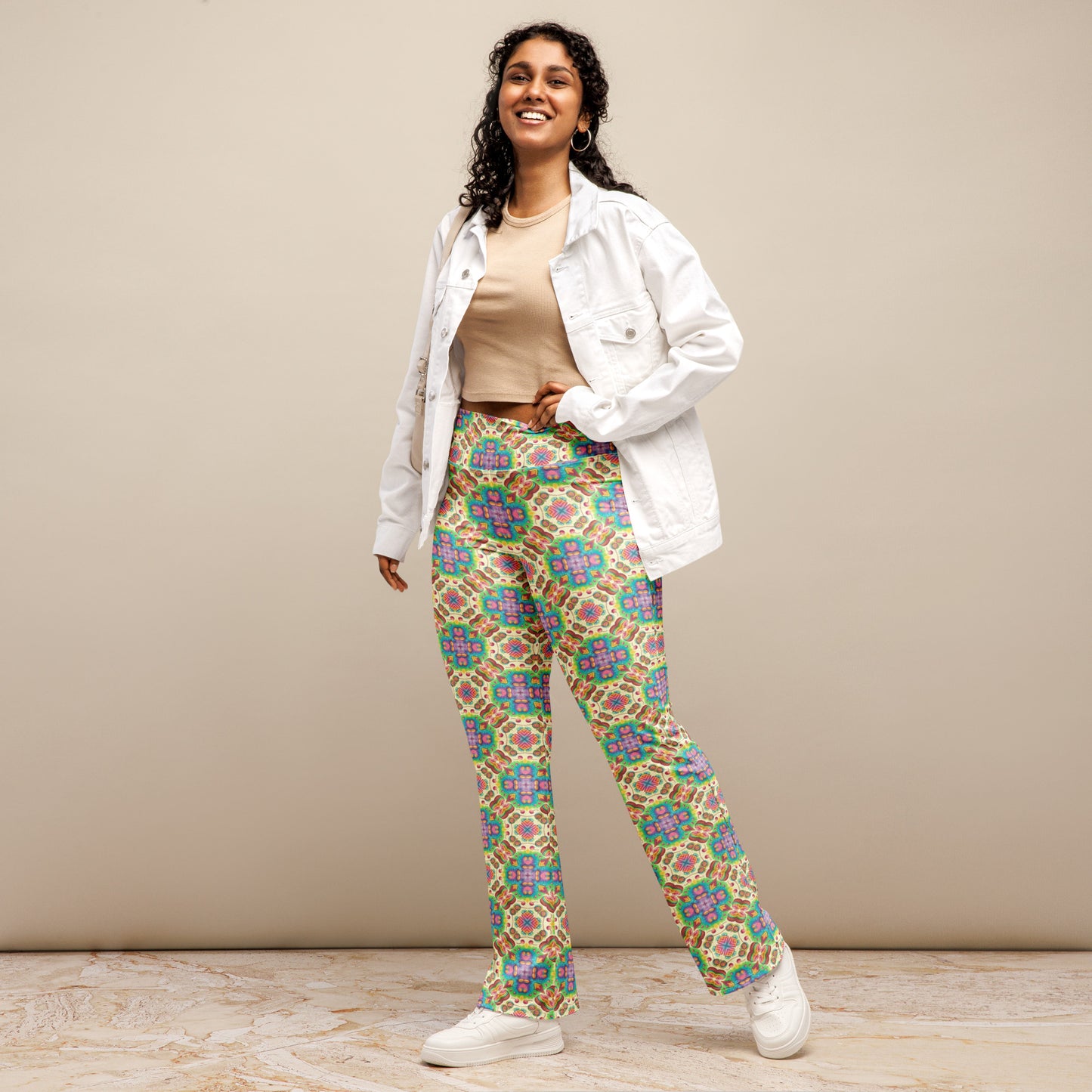  High-rise flared leggings with a vibrant retro garden pattern, featuring a high waist and flared bottoms, worn by a smiling model.