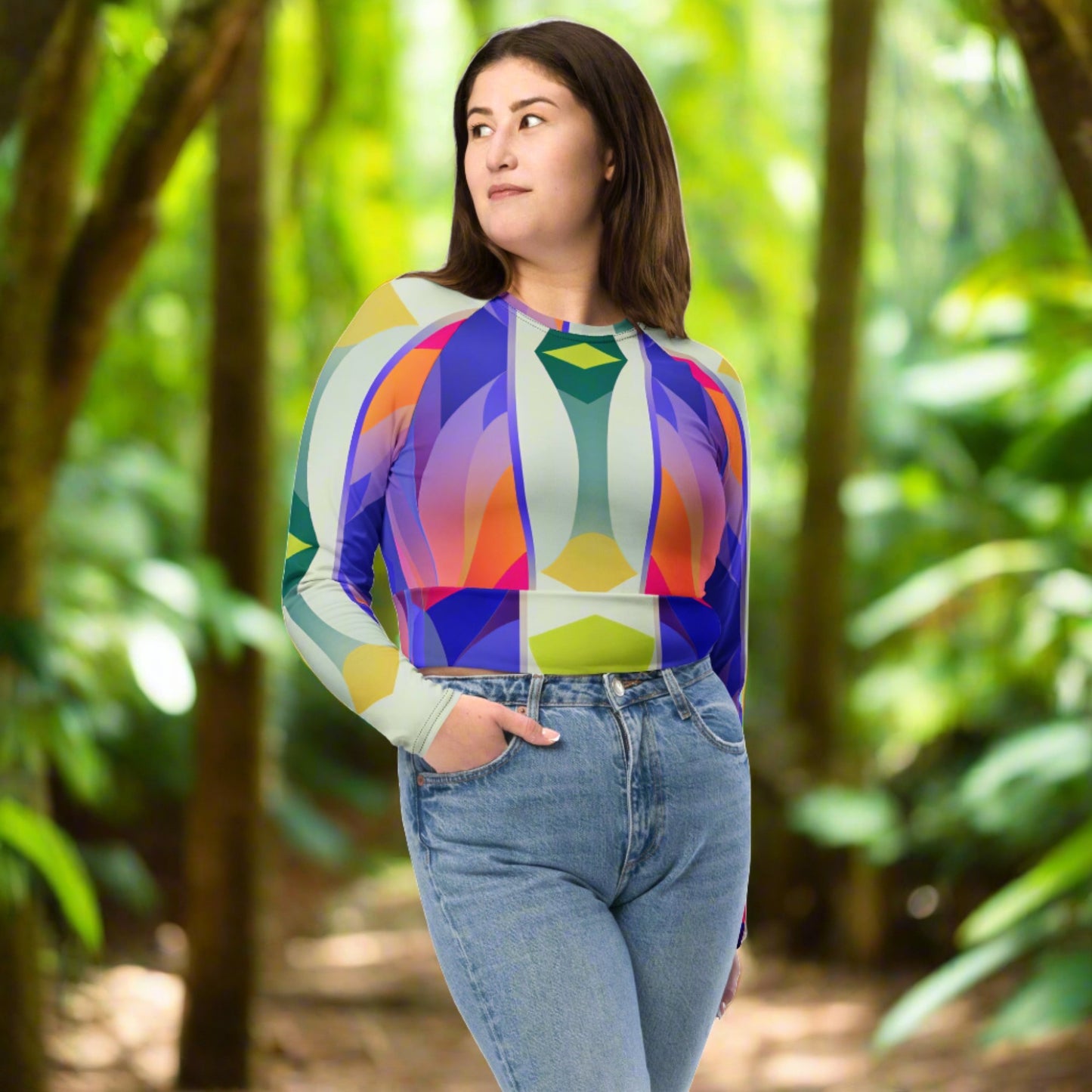 Woman wearing Recycled Long-Sleeve Crop Top in Perry, standing confidently, showcasing the bold geometric pattern and wide waistline band.