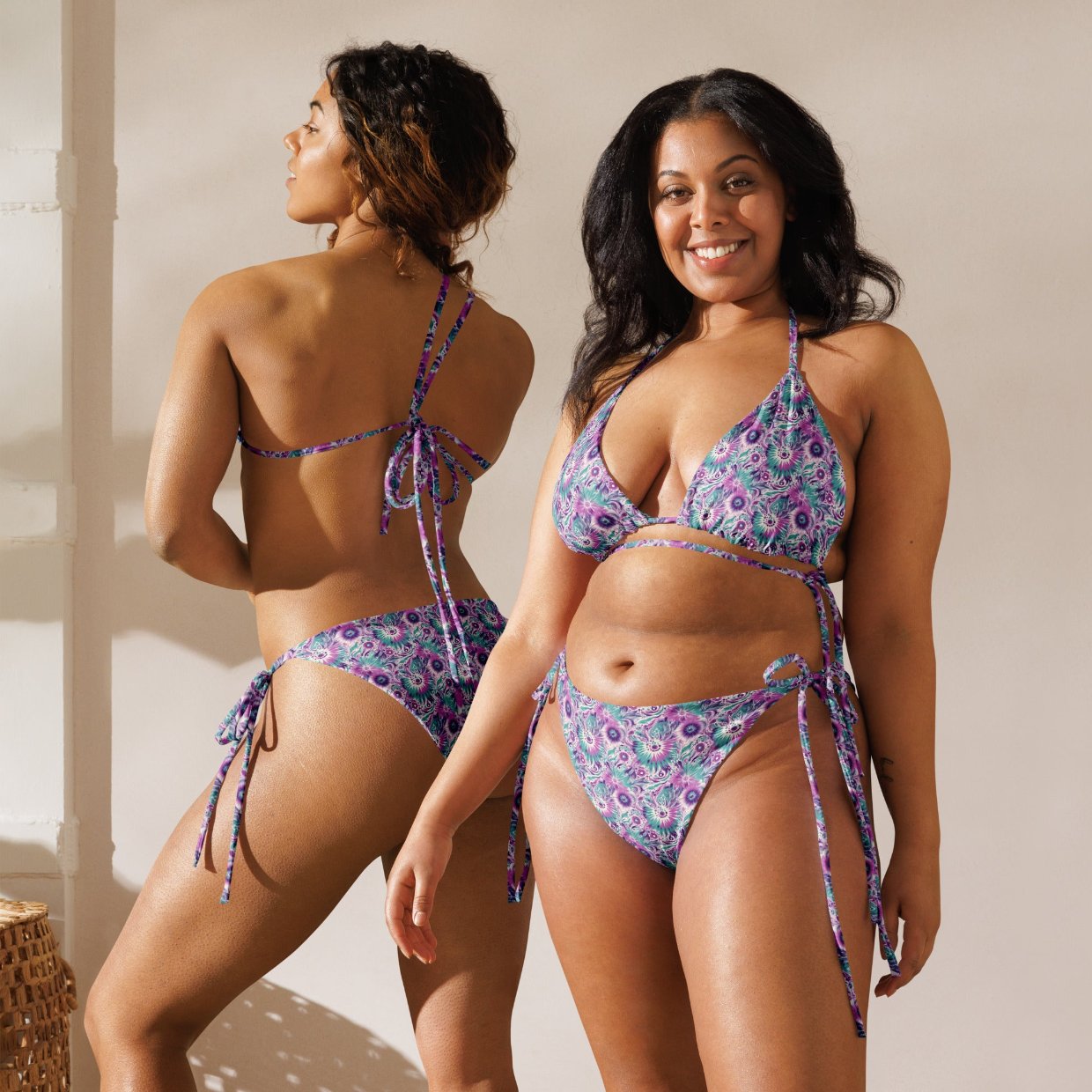 Recycled string bikini with a whimsical floral pattern in purple and green, featuring adjustable ties and eco-friendly materials.