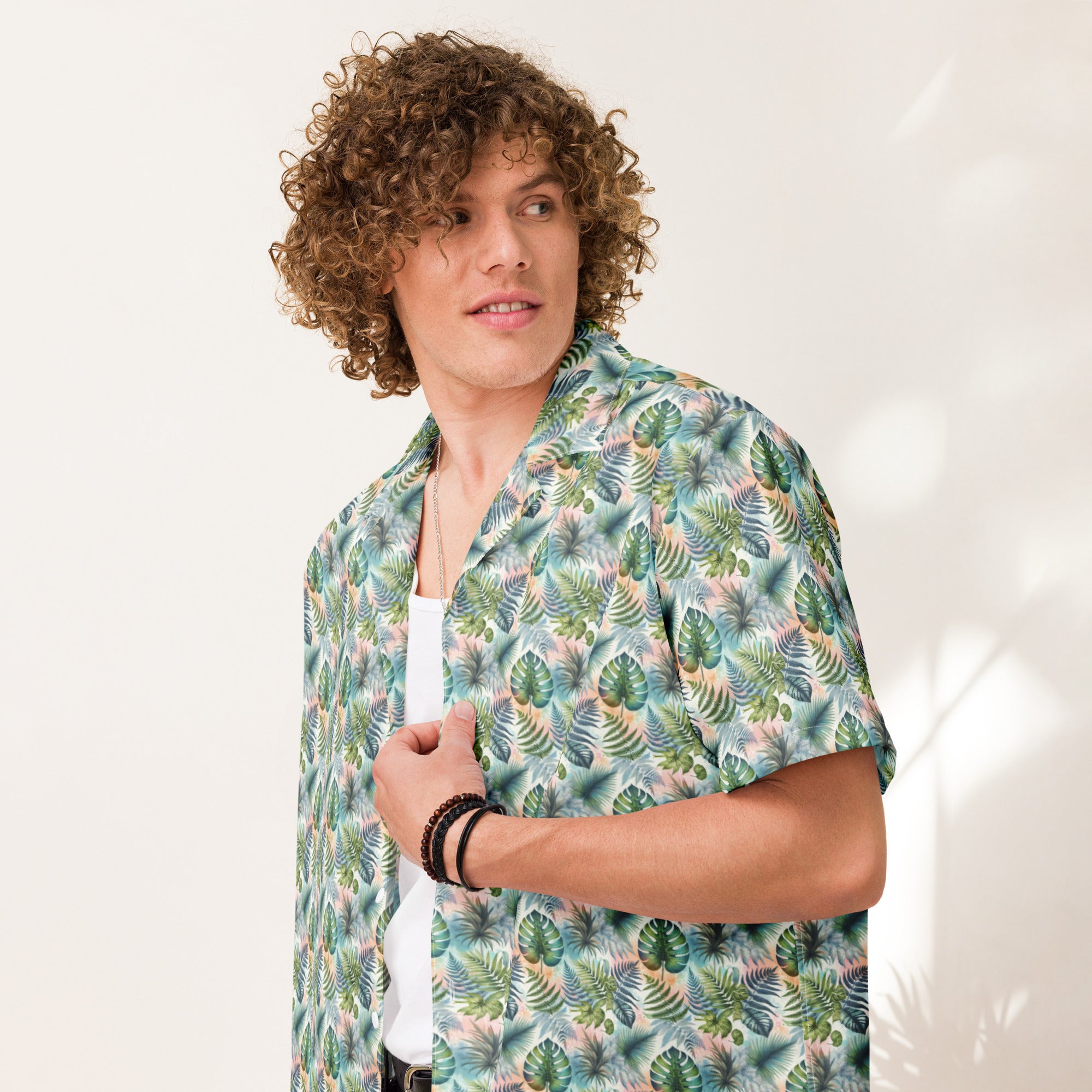Person wearing Unisex Button Shirt in Jungle Fever, featuring a lush tropical print, lightweight and moisture-wicking material, perfect for hot summer days.