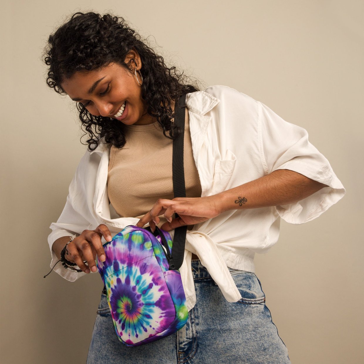 Woman wearing a Utility Crossbody Bag in Tie-Dye Adventure, featuring a vibrant tie-dye pattern, adjustable strap, and roomy pockets, perfect for any adventure.