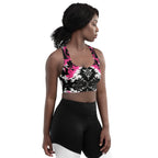 Front view of the Dark Blush Longline Sports Bra featuring a black, white, and pink tie-dye gothic design with a longline cut for extended coverage worn by a model.