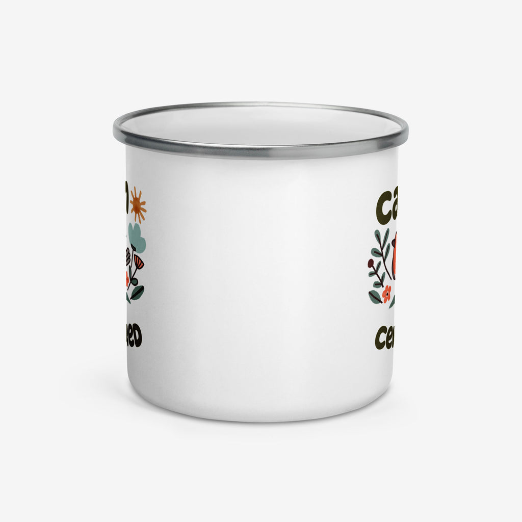 White enamel mug with floral designs and text on a white background