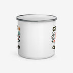White enamel mug with floral designs and text on a white background