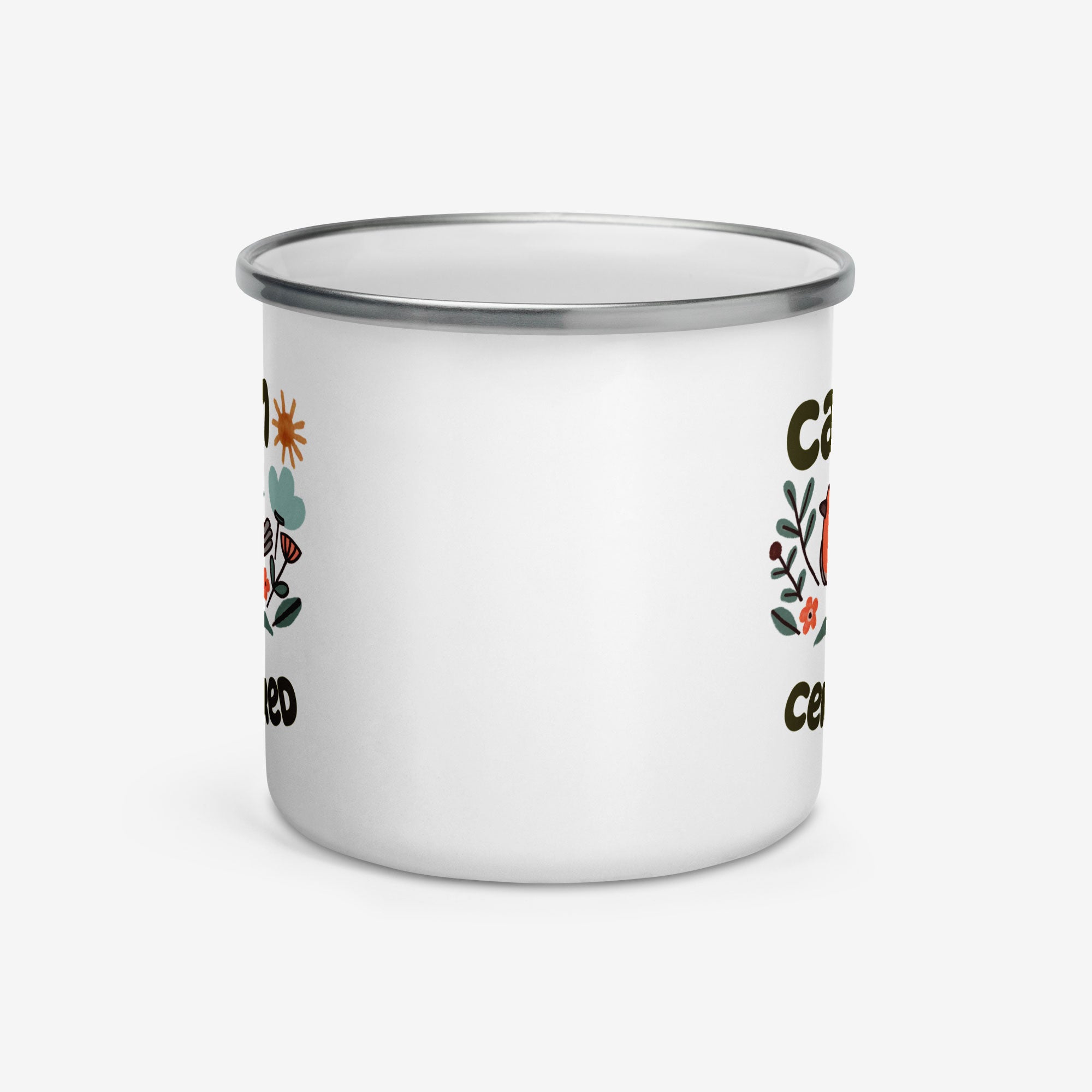 White enamel mug with floral designs and text on a white background