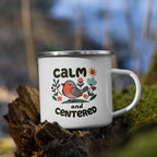 Mug with 'Calm and Centered' text and a bird illustration on a natural background