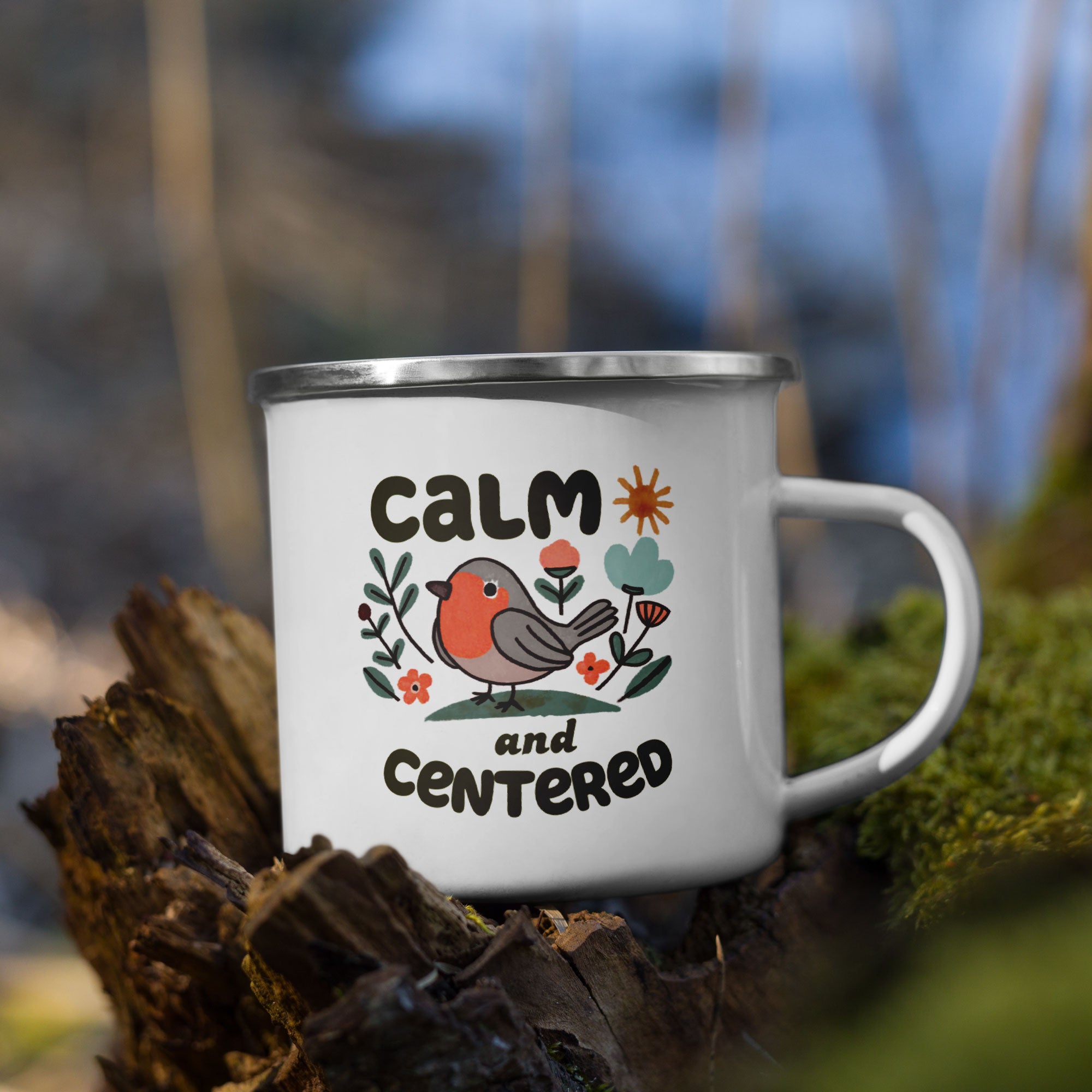 Mug with 'Calm and Centered' text and a bird illustration on a natural background