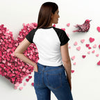 Woman wearing ErdeGora micro rib raglan baby tee front view, white with black sleeves and embroidered Love Birds heart with text, back view.