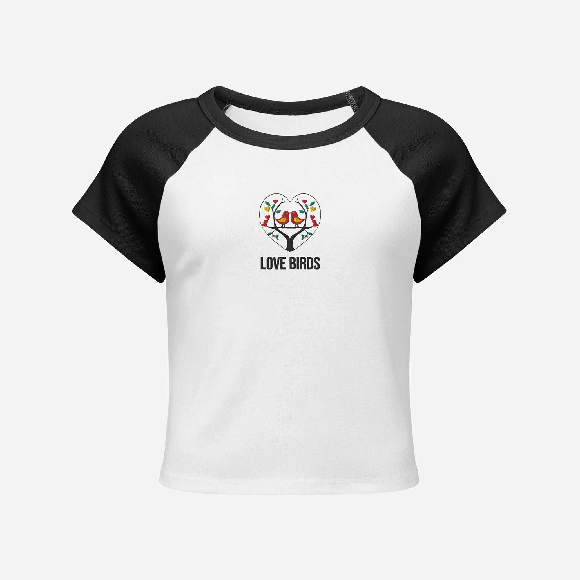 Women’s micro rib raglan baby tee front view, white with black sleeves and embroidered Love Birds heart with text.