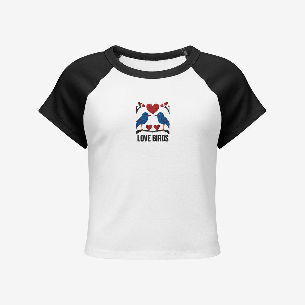 White t-shirt with black sleeves featuring an embroidery design of love birds and hearts on a white background.