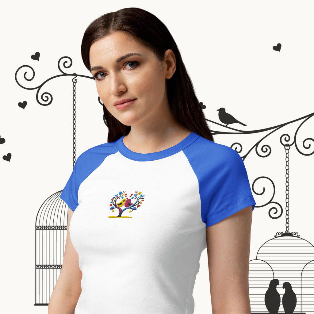 Woman wearing a white and blue baseball shirt with a colorful design on a decorative background