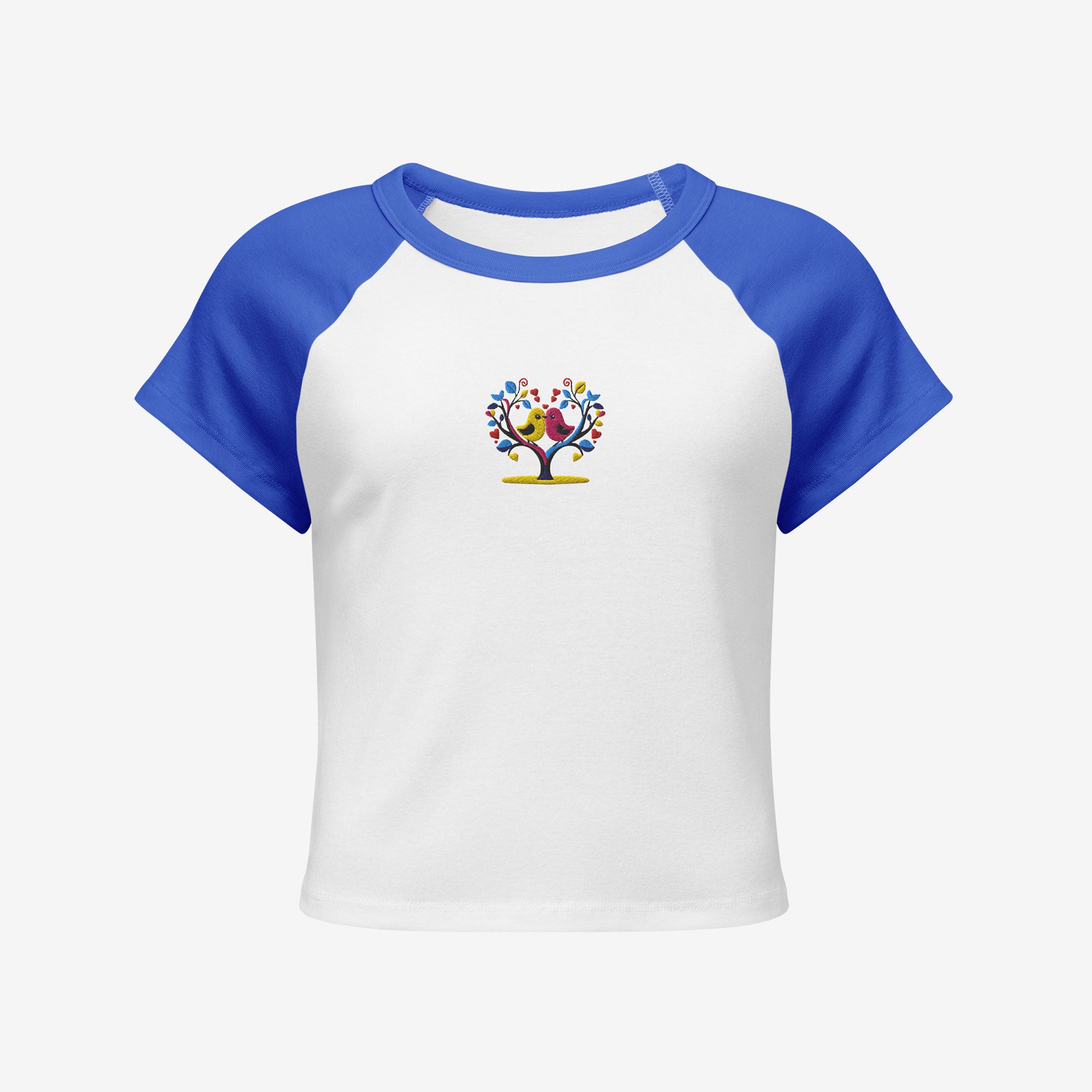 White t-shirt with blue sleeves featuring an embroidery design of lover birds on a heart shaped tree on a white background.