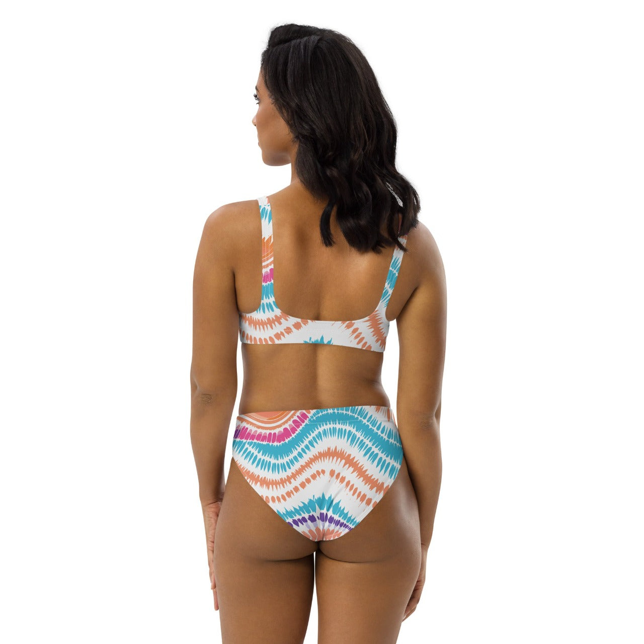 Female model wearing ErdeGora’s white Crush Waves bikini, back view, highlighting the high-waisted design and the continuous wave print