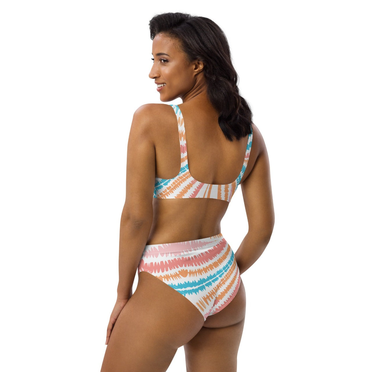 Back-side view of a model wearing the Recycled High-Waisted Bikini Peachy Twister, emphasizing the retro high-rise style and playful pattern.