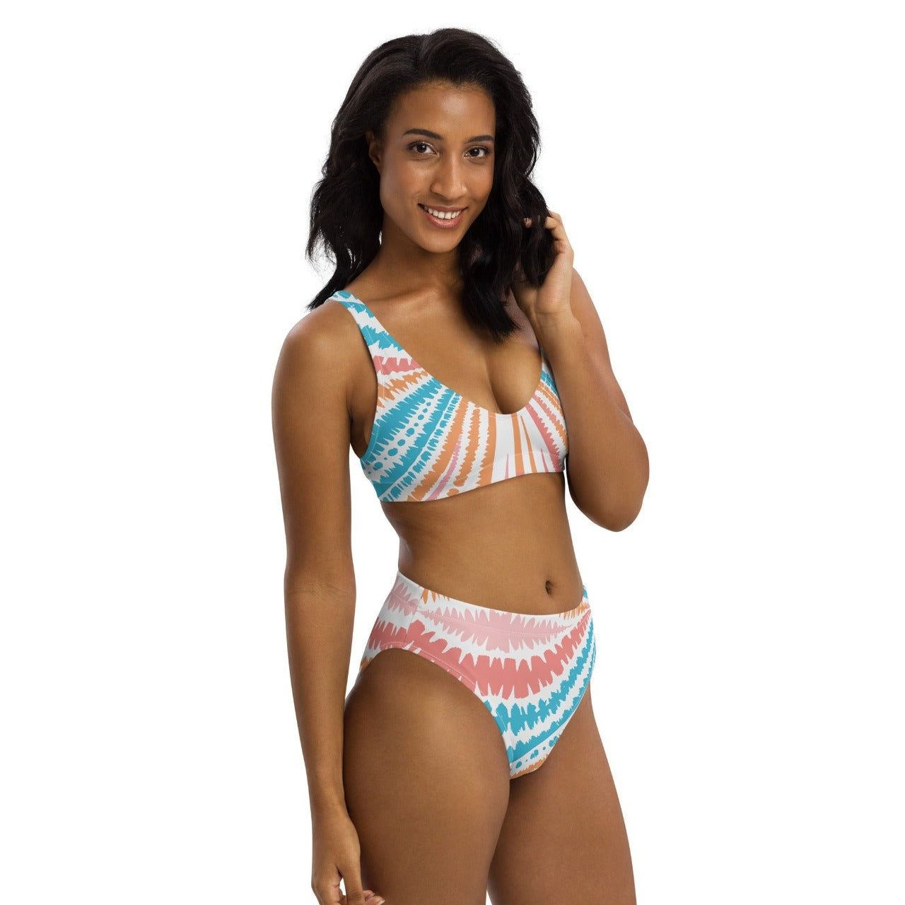 Front-side view of a model sporting the Recycled High-Waisted Bikini Peachy Twister, highlighting the suit's curve-loving fit and sweet, summery vibe.