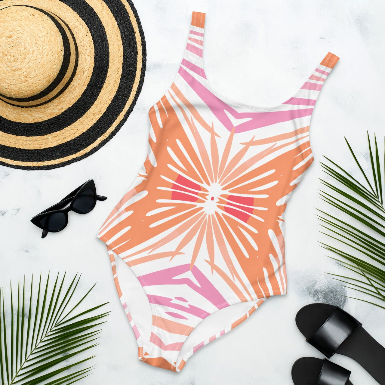 Flat front view of Peachy Coral Reef one-piece swimsuit, displaying the vibrant coral pattern and peachy tones.