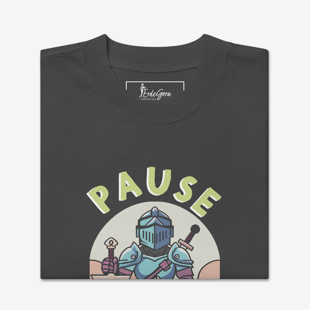 Folded t-shirt with a graphic design of a knight holding swords and the word 'PAUSE' on a white background.
