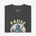 Folded t-shirt with a graphic design of a knight holding swords and the word 'PAUSE' on a white background.