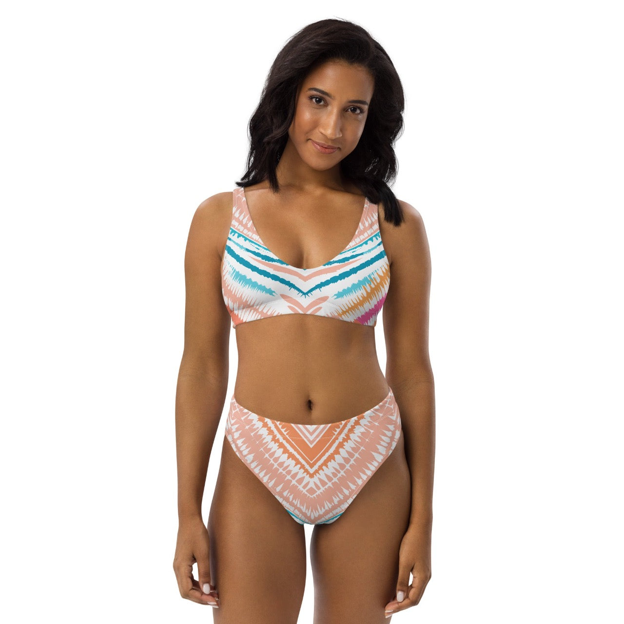 Female model wearing ErdeGora Recycled High-Waist Bikini Peachy Blues Tribal Splash, front view, featuring the flattering high-waisted bottom and vibrant tribal print top.