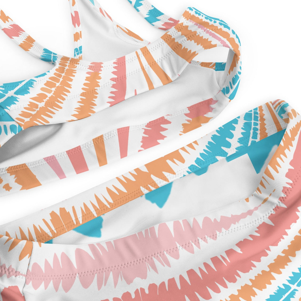 Detail of Recycled High-Waisted Bikini's Peachy Twister fabric, close-up showcasing the intricate swirl design and soft, recycled material for the eco-friendly fashionista.