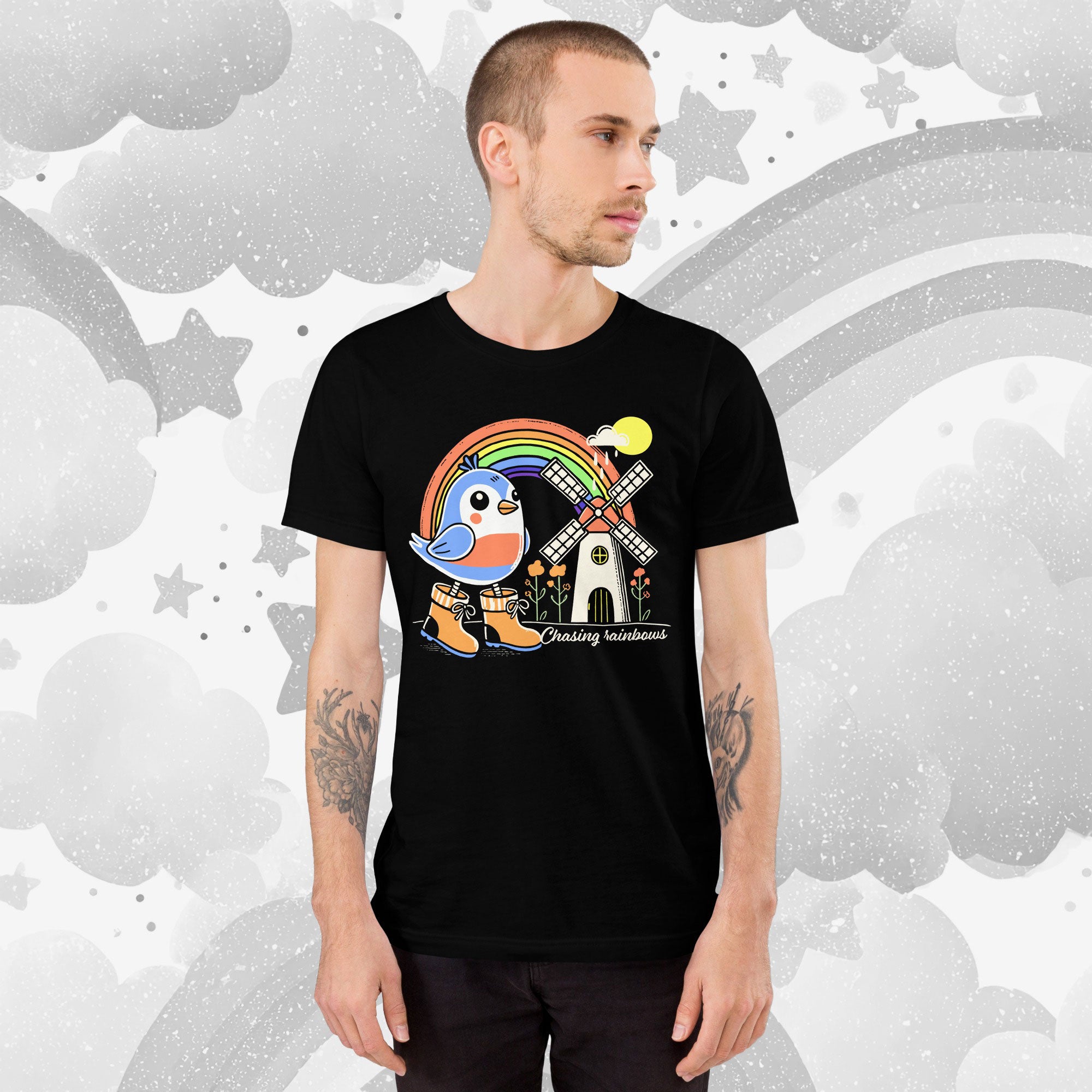 Person wearing a black t-shirt with a colorful graphic design on a gray background
