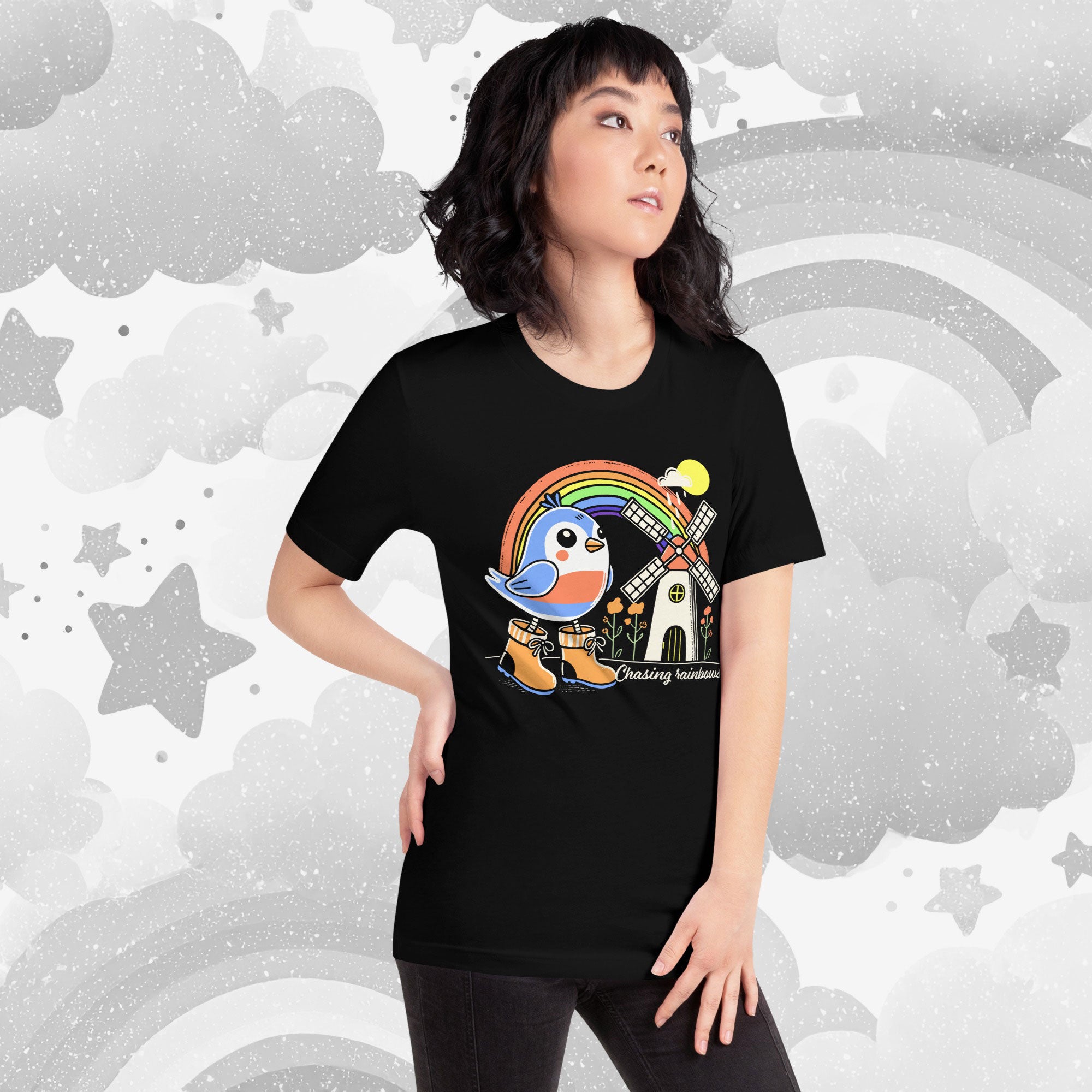 Person wearing a black t-shirt with a colorful graphic design against a starry background