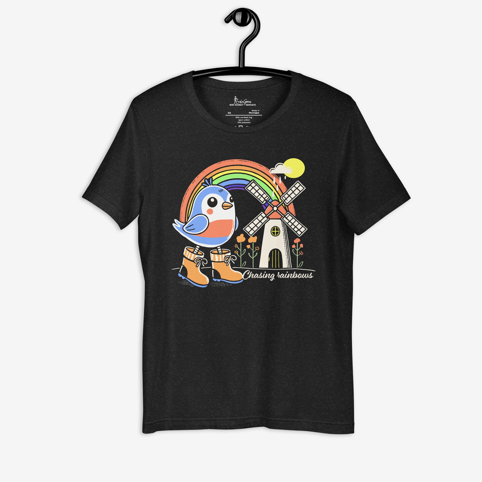 Black t-shirt with a colorful graphic of a bird, rainbow, and windmill on a hanger.