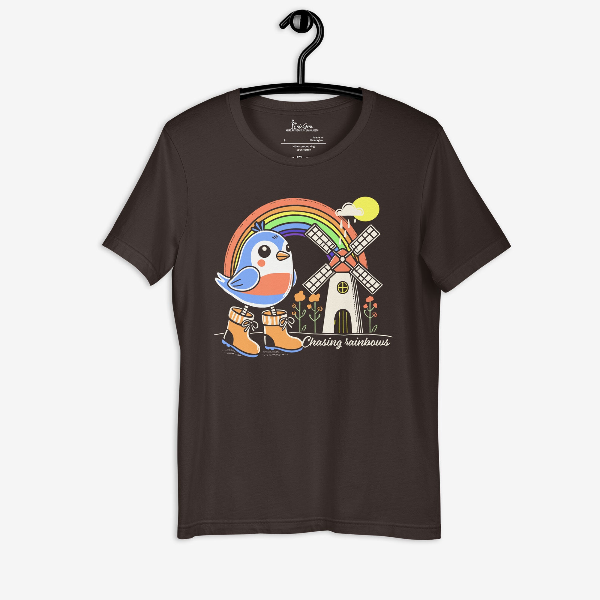 Black t-shirt with a colorful graphic of a bird, rainbow, and windmill on a hanger.