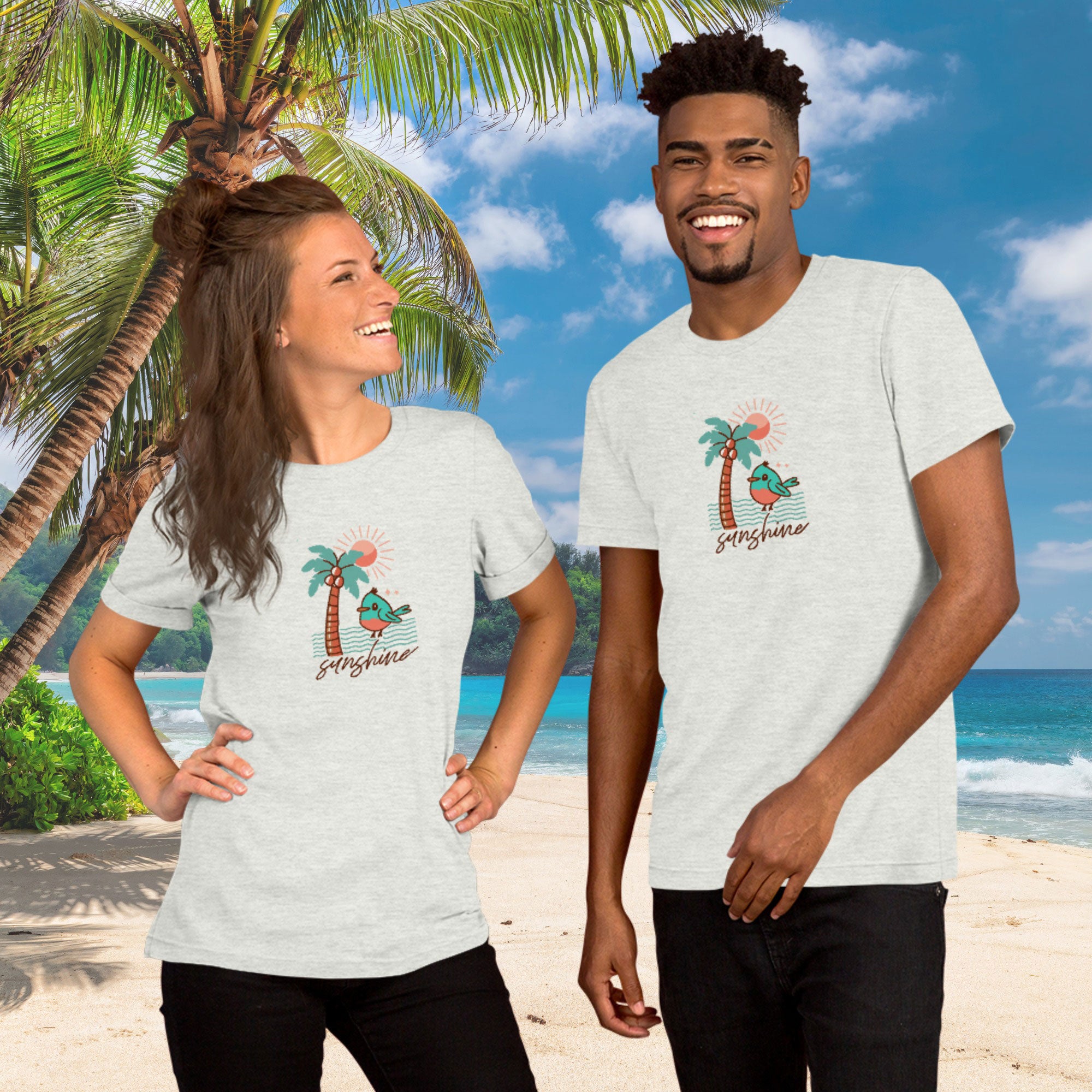 Two people wearing t-shirts with a palm tree and flamingo design on a beach background