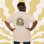 Person wearing a beige t-shirt with a sun design and 'Happiness' text on the back, against a yellow wavy patterned background.