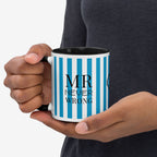 Hand holding a mug with blue and white striped pattern and 'MR NEVER WRONG' text.