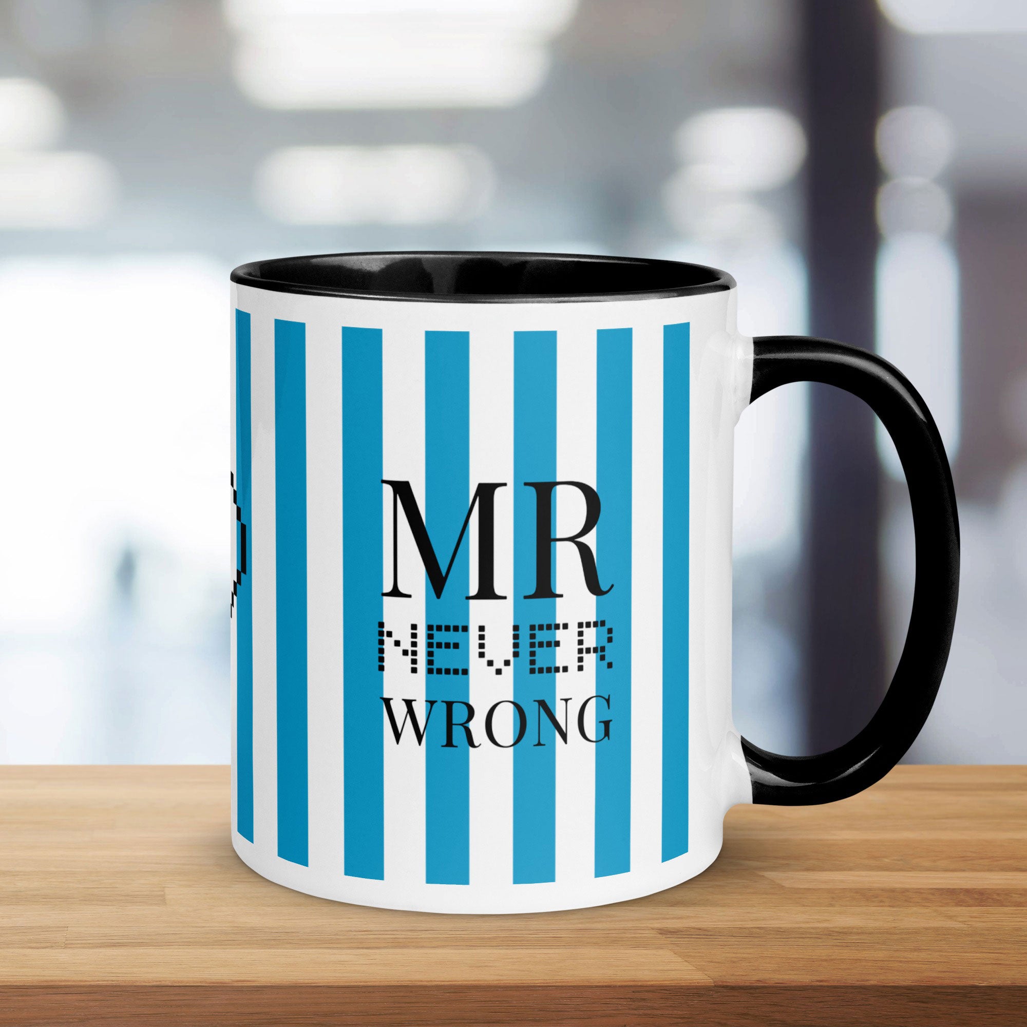 Mug with blue and white striped design and 'MR NEVER WRONG' text on a wooden surface.