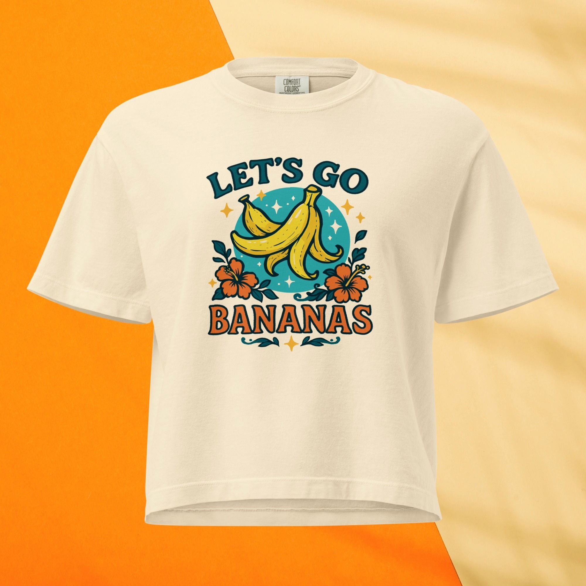 Beige t-shirt with 'Let's Go Bananas' graphic design on an orange and beige gradient background