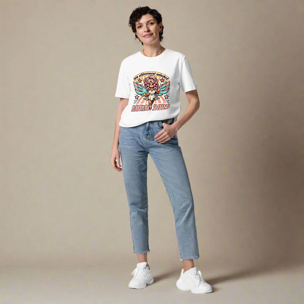 Women wearing white ErdeGora T-shirt with text 'New Achievement Unlocked: Mama 2025' depicted with a playful, pink and blue, gaming-inspired design featuring a warrior female.