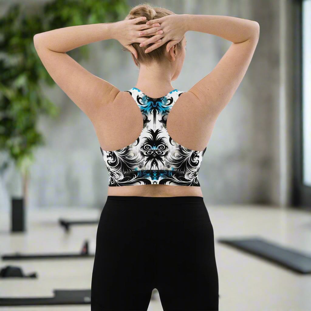 Model wearing the Ghostly Glimmer Longline Sports Bra during a gym session, highlighting its style and functionality. Back view