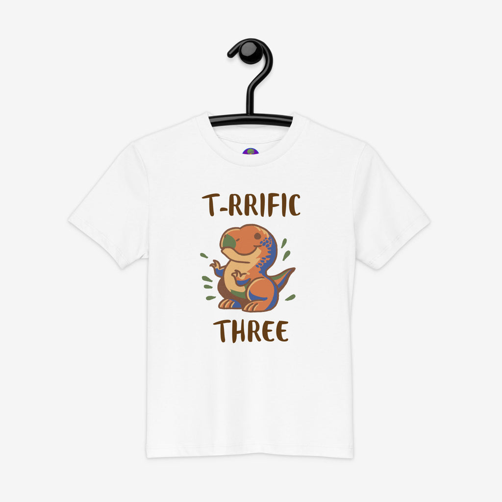 White t-shirt with a dinosaur graphic and text on a hanger against a white background
