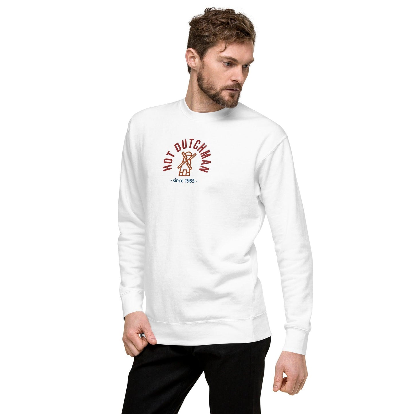 man in white sweatshirt , front view, design a windmill simple embroidery in orange, top written in red hot dutchman  and under in blue since 1985, the year is customizable.