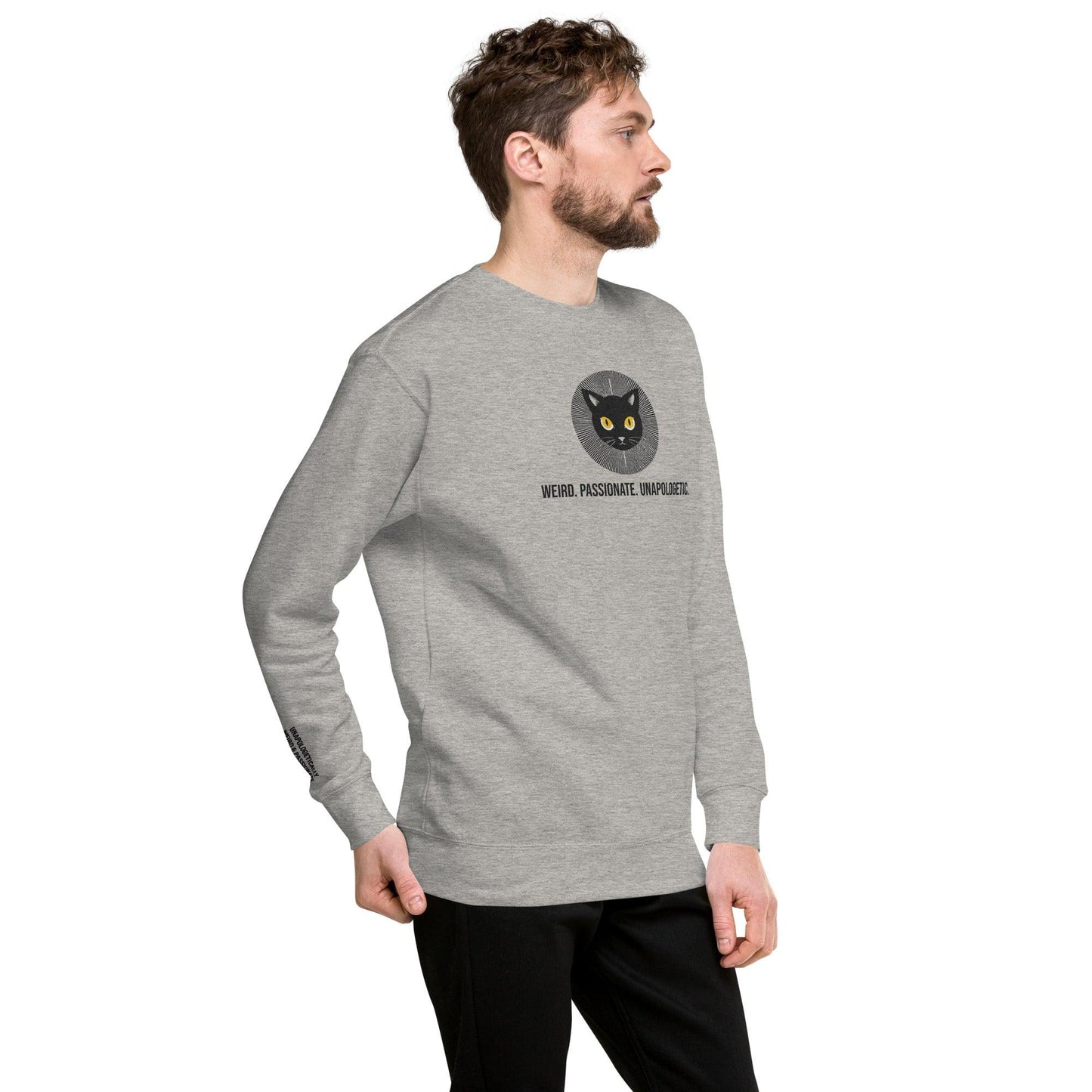 man in grey sweatshirt, right front view, with a black cat with yellow eyes embroidery radiating confidence and the erdegora tag line Weird. Passionate. Unapologetic