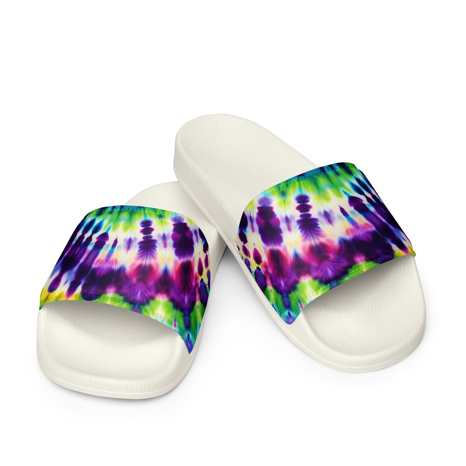 Pair of Women’s Slides in Festival Vibes, showcasing a vibrant tie-dye pattern on the cushioned upper strap with a contoured and textured footbed.