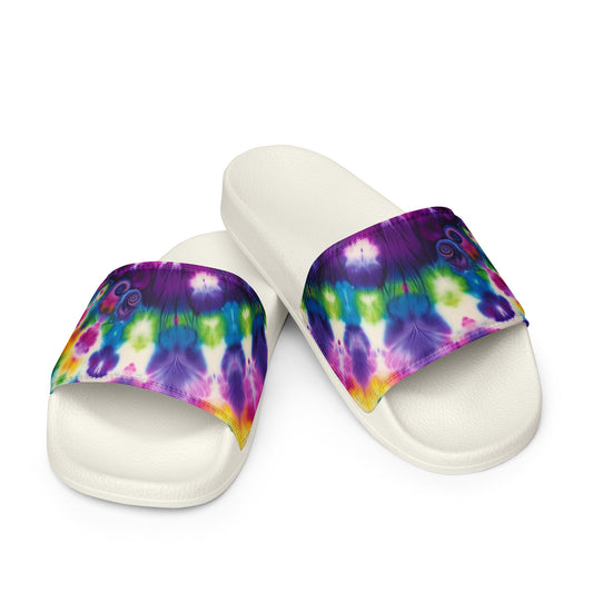 Pair of Women’s Slides in Kaleidoscope Dream, showcasing a vibrant tie-dye pattern on the cushioned upper strap with a contoured and textured footbed.